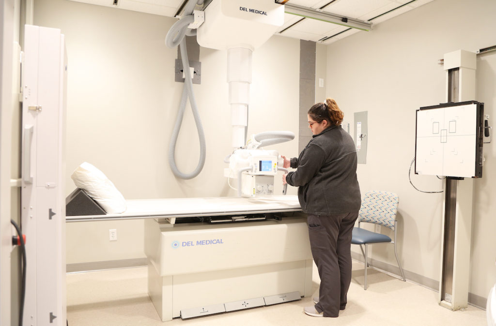 radiology technician operating xray equipment